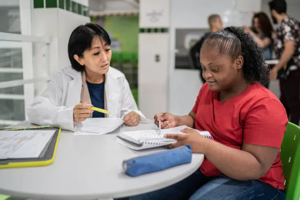 A support professional reviewing notes together with a young adult client
